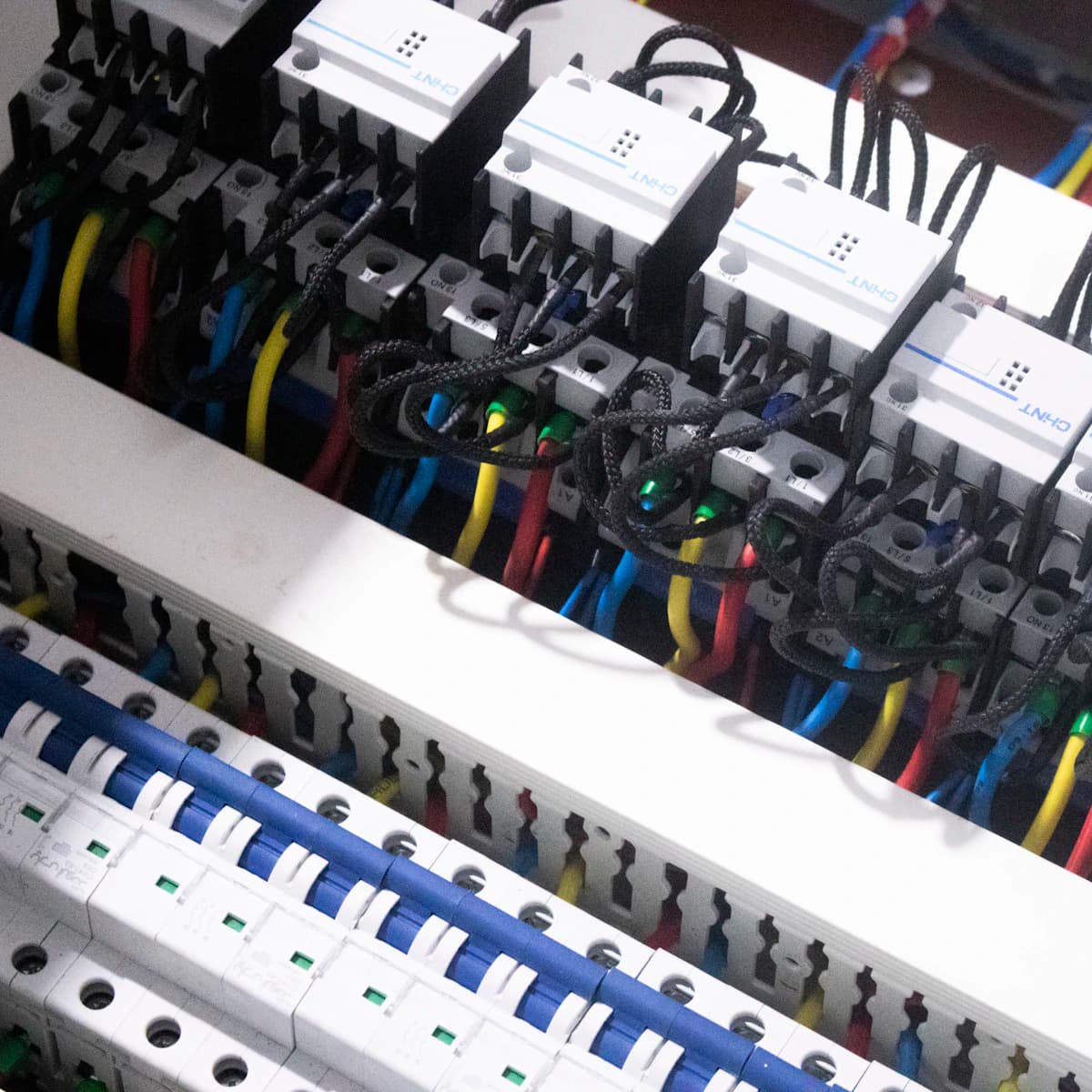 Close-up of wiring and switchgear terminals inside a panel